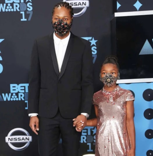 Image of Kendrick Lamar with his daughter