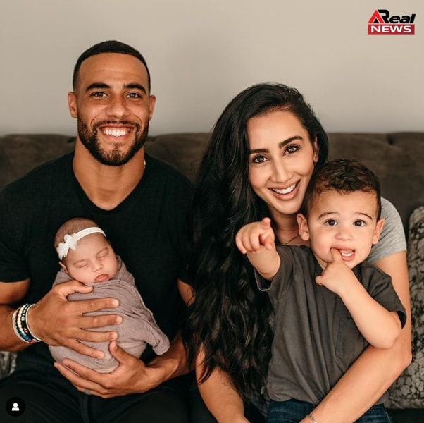 Image of Micah Hyde with his wife and kids 