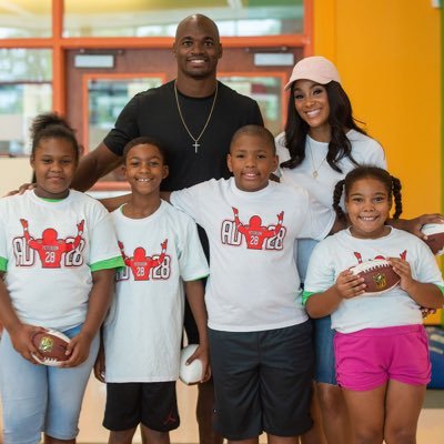 Image of Adrian Peterson and Ashley Brown with their kids , Tyrese Robert Ruffin, Axyl Eugene Peterson, Adeja Peterson, and Adrian Peterson Jr.