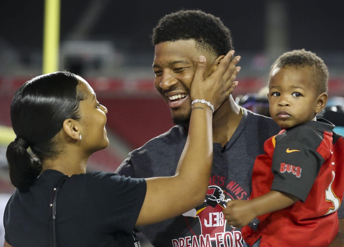 Image of Jameis Winston with his wife, Breion Allen, and their first born son, Antonor