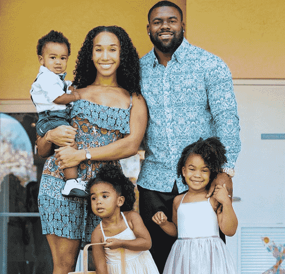 Image of Mark Ingram, Jr. with his wife, Chelsea Ingram, and their kids